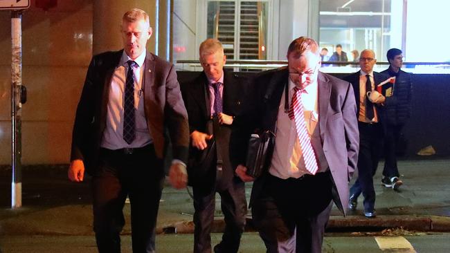 Three Australian Federal Police officers walk across the road outside the main entrance to the ABC building located at Ultimo in Sydney after raids on June 5, 2019. Picture: David Gray/AAP