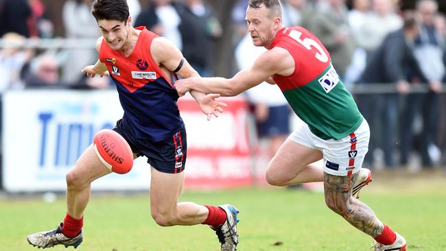 Mt Eliza’s Robbie Turnbull leads Pines defender Adam Marriner to the ball in the qualifying final at Frankston Park. Picture: Jason Sammon.