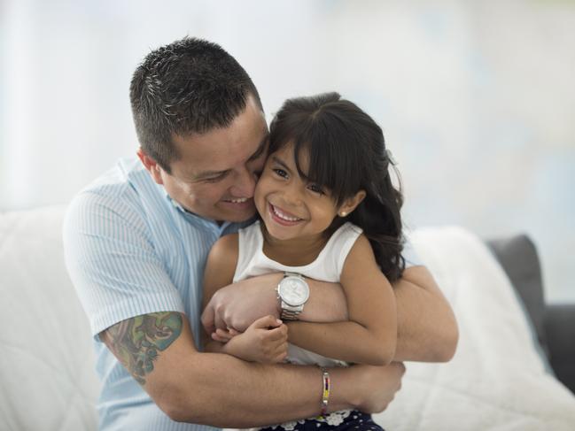 A father is giving his daughter a hug on father's day.