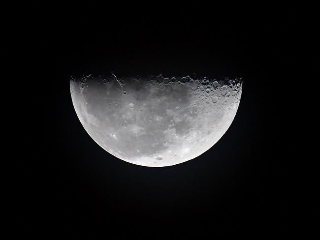 A half moon rises as the Artemis I unmanned lunar rocket prepares to lift off from pad 39B at NASA's Kennedy Space Center in Cape Canaveral, Florida, on November 16, 2022. Picture: AFP