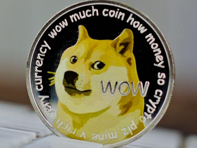 Digital currency physical metal dogecoin coin on white computer keyboaed.  Picture: istock
