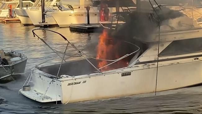 The cruiser in flames at Brooklyn Marina on the Hawkesbury River today. Pictures: Greg Manning