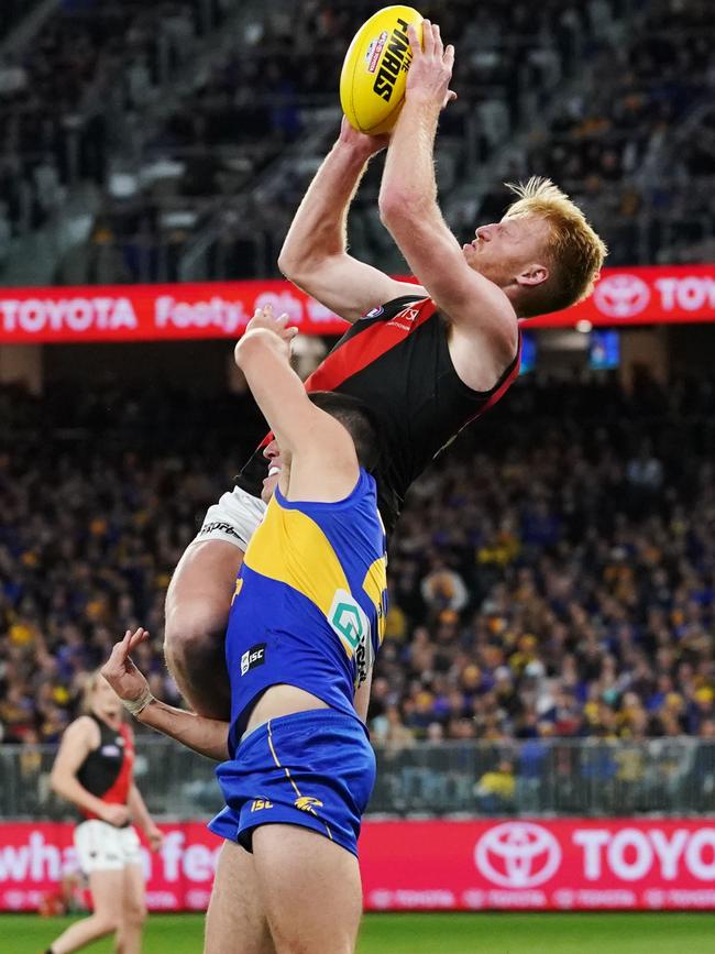 Aaron Francis flies for a mark over Dom Sheed. Picture: AAP