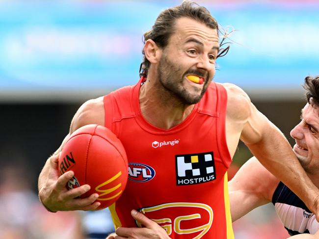 GOLD COAST, AUSTRALIA - APRIL 02: Lachie Weller of the Suns attempts to break away from the defence Mark O'Connor of the Cats during the round three AFL match between Gold Coast Suns and Geelong Cats at Heritage Bank Stadium, on April 02, 2023, in Gold Coast, Australia. (Photo by Bradley Kanaris/Getty Images)