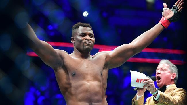 TOPSHOT - UFC 270 heavyweight world champion Cameroon's Francis Ngannou (C) reacts on introduction for fight against France's Ciryl Gane for the heavyweight title at the Honda Center in Anaheim, California on January 22, 2022. (Photo by Frederic J. BROWN / AFP)