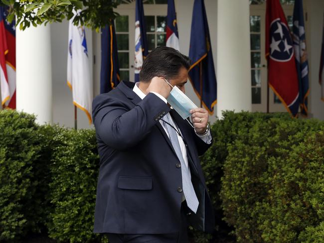 A Secret Service agent puts his mask back on after Donald Trump’s press conference at the White House. Picture: AP