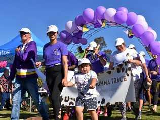 LANDERS LEAD: Bryan Vickery and Kaitlyn Landers, of team The Face of Mumma Trace, lead the lap for survivors and carers at Relay for Life in Roma on Saturday. Picture: Ellen Ransley