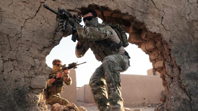 Chris Moore captured this image of the Special Operations Task Group members enter the training compound at Multi National Base Tarin Kowt. Picture: Supplied