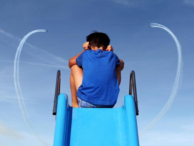 A little boy plugs his ears to the deafening noise of the spectacular Italian Tricolour Arrows. Picture: Alessandro Deluigi