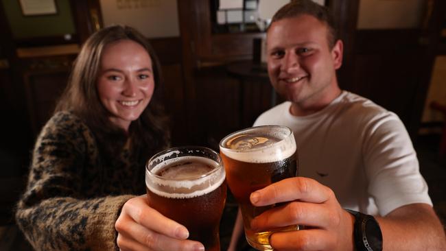 Darcie Hill and Michael Cody have Sydney's first post-lockdown beers at the Fortune of War Pub in the Rocks. Picture: Damian Shaw