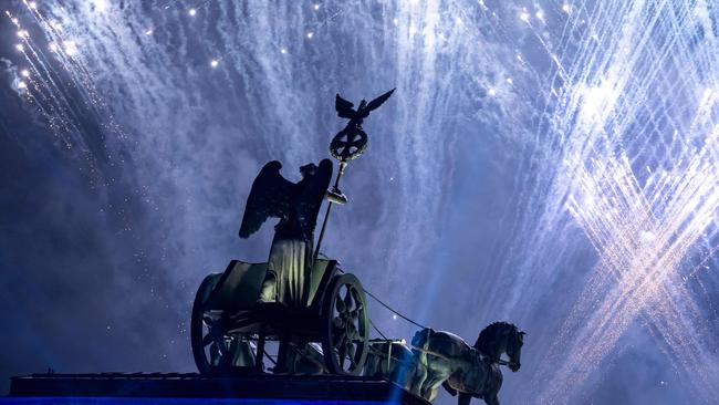 Fireworks over the Brandenburg Gate where people gathered 30 years ago to tear down the wall with hammers. Picture: Bernd von Jutrczenka / dpa / AFP