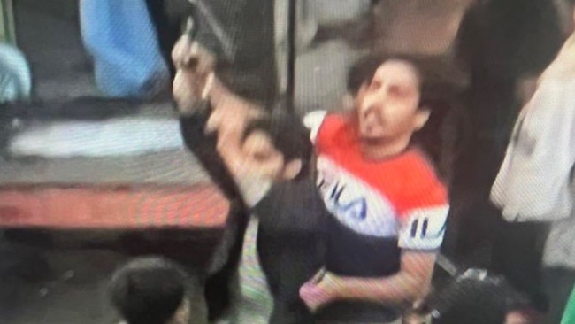 Footage aired by Al Jazeera showed this man in orange and white struggling with a gunman. Picture: Al Jazeera