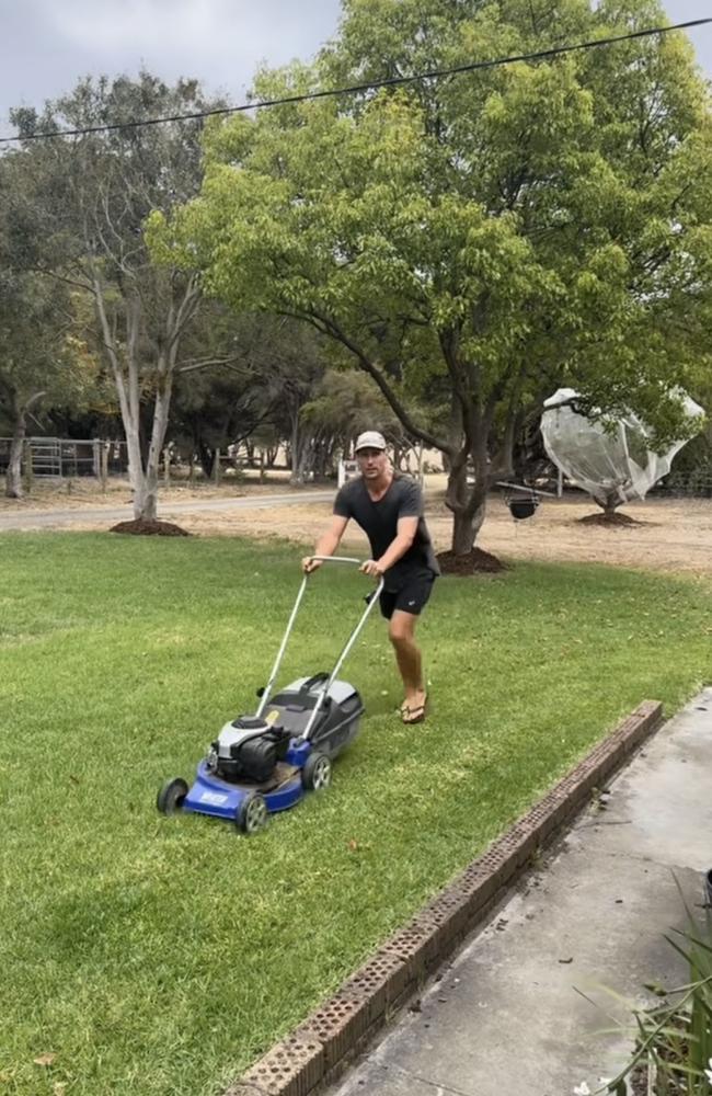 Jeremy Cameron mows the lawn in preparation for his farm wedding.