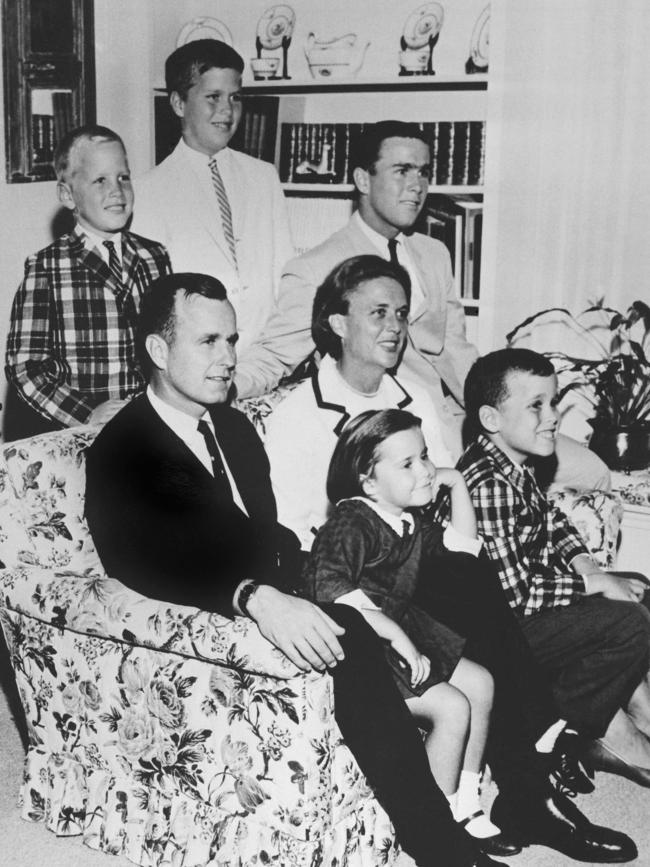 The bush family in 1964 — George H.W. Bush sits on a couch with his wife, Barbara, and their children. (From behind) Neil, Jeb, George, (in front) Dorothy and Marvin. Picture: AP