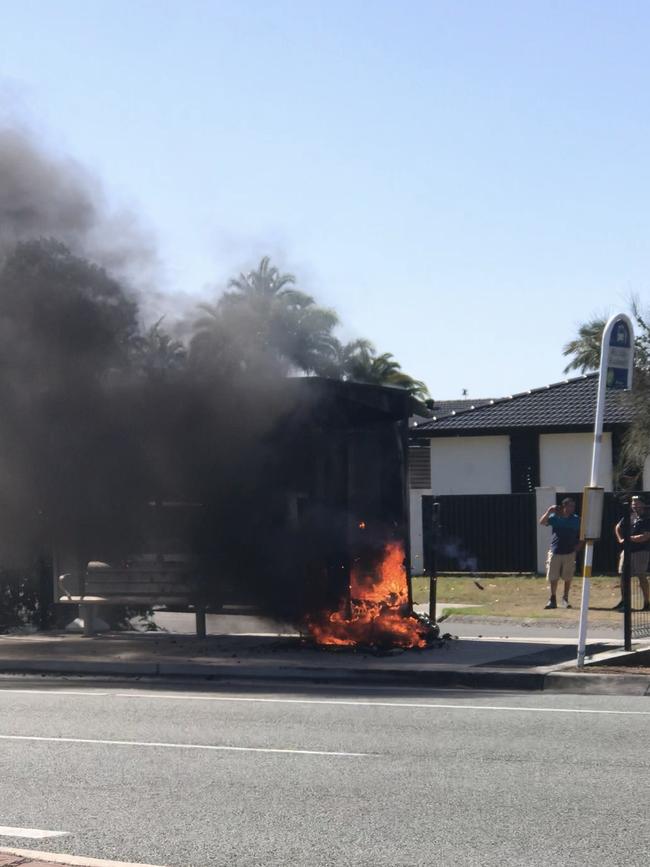 A bus stop goes up in flames at Broadbeach Waters, Gold Coast. Picture: Scarlett Madden