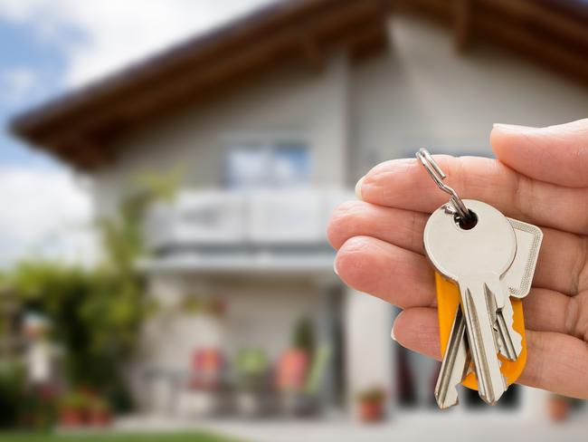 Close-up Of Person Hand Holding House Key In Hand