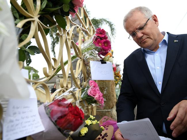 Prime Minister Scott Morrison looks at floral tributes to the victims of the Christchurch terror attack during a visit to the Lakemba Mosque, in  Lakemba, in south west Sydney, Saturday, March 16, 2019. The Prime Minster met with Islamic community leaders following the terror attack in Christchurch, New Zealand. (AAP Image/Dan Himbrechts) NO ARCHIVING