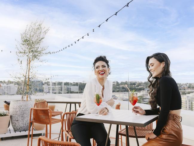 Pamela Rocha and Chanelle Monique enjoying cocktails at The Lady Banks Rooftop bar at Bankstown Sports.