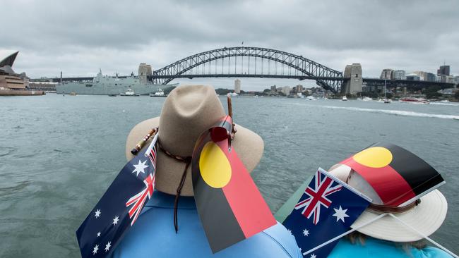 Participants wearing Australian and Aboriginal flags are seen aboard a ferry on Sydney Harbour on Australia Day in 2018. Picture: AAP