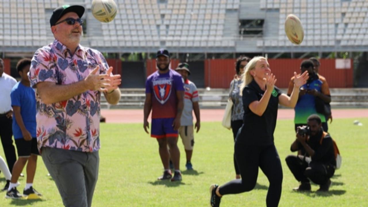 Assistant Trade Minister Tim Ayres and ARL Commissioner Kate Jones on a trade delegation in Papua New Guinea with kids practising rugby league. Picture: Supplied