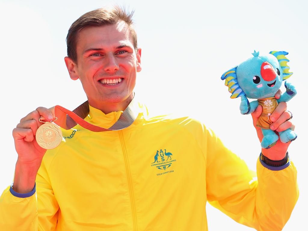 Dane Bird-Smith of Australia celebrates after wining the Men's 20km Race Walk final. But his four-legged friends, Pina and Rocky perhaps deserve some of the credit.  Picture: Scott Barbour/Getty Images