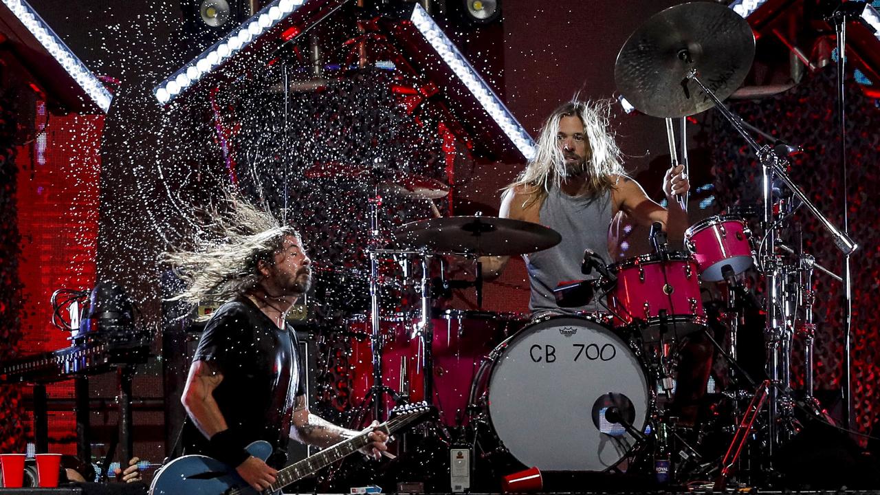 Foo Fighters' drummer Taylor Hawkins and lead singer Dave Grohl on stage at the Lollapalooza 2022 music festival in Santiago. (Photo by JAVIER TORRES / AFP)