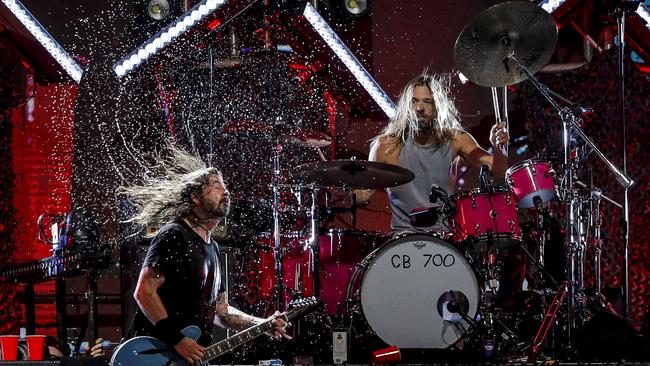 Foo Fighters' drummer Taylor Hawkins and lead singer Dave Grohl on stage at the Lollapalooza 2022 music festival in Santiago. (Photo by JAVIER TORRES / AFP)