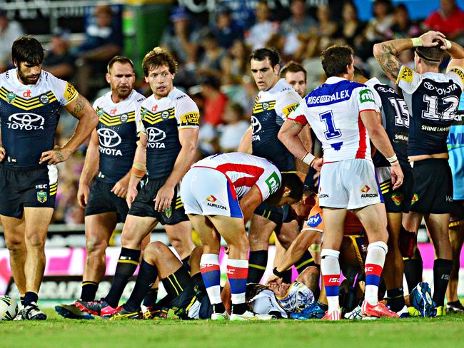 Johnathan Thurston lies on the ground after a hit.