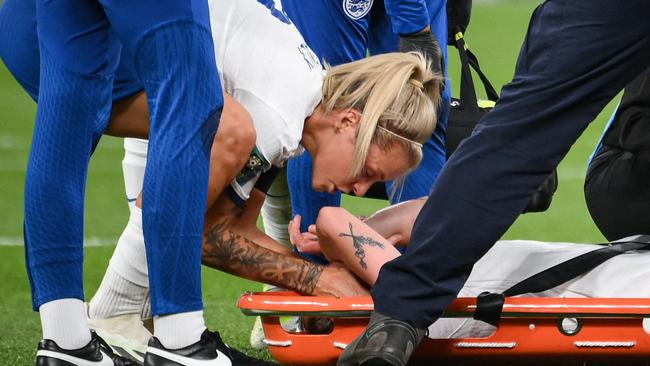 Keira Walsh is comforted by Rachel Daly as she is taken off on a stretcher after a knee injury.