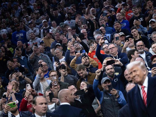 Attendees cheer as US President Donald Trump attends the men's NCAA wrestling competition in Philadelphia, Pennsylvania. Picture: AFP