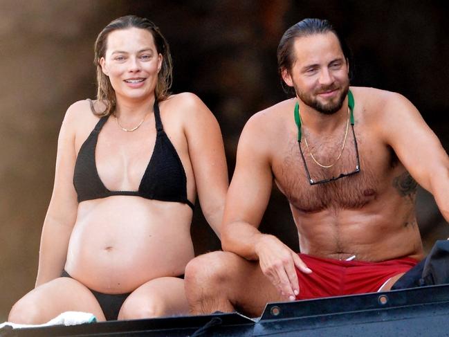 **Fees Apply** No AUS No NEWS.COM ** ONE TIME USE **AU_3013299 - Palmarola, ITALY  -  *PREMIUM-EXCLUSIVE*  -  - Margot Robbie, glowing with pregnancy, is seen having an adventurous holiday on Palmarola Island with her husband, Tom Ackerley. The couple enjoys jet skiing together, with Margot embracing the fun despite her baby bump. She later takes a refreshing swim, jumping off a dinghy, and wraps up the day with a relaxing beer with friends Brian Grazer and Veronica Smiley in a picturesque house built into the rock by local fishermen.  Pictured: Margot Robbie, Tom Ackerley  BACKGRID Australia 29 AUGUST 2024   BYLINE MUST READ: CIAOPIX / COBRA TEAM / BACKGRID  Phone: + 61 419 847 429 Email:  sarah@backgrid.com.au