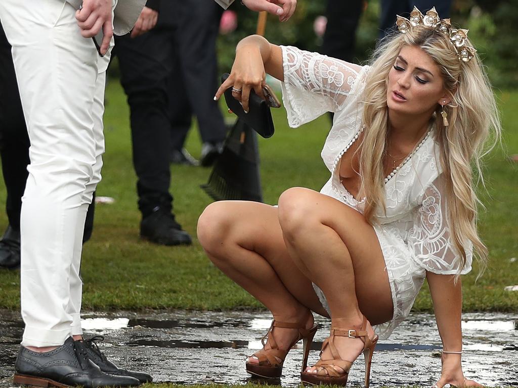 MELBOURNE, AUSTRALIA - NOVEMBER 06: Racegoers stumble as they make their way home following Melbourne Cup Day at Flemington Racecourse on November 6, 2018 in Melbourne, Australia. (Photo by Scott Barbour/Getty Images)