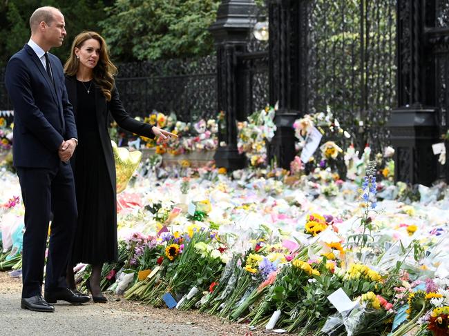 Prince William and Kate Middleton look at the sea of floral tributes left outside Sandringham. Picture: Getty Images.