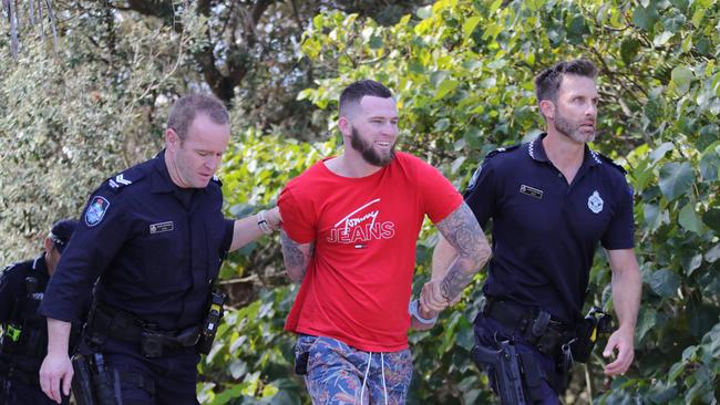 Police chase and arrest a runner from Gold Coast Airport at Coolangatta. Picture: Glenn Hampson