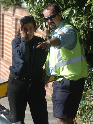 A council worker speaks to the family about the mess in 2005. Picture: John Grainger 