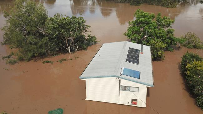 A house is seen surrounded by flood waters from the Mary River in the town of Tiaro, where Mr Bottcher worked at an excavator company and was sadly found after he was swept away by flood waters. (AAP Image/Darren England)