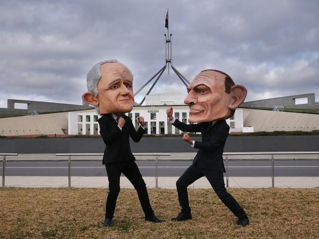 Two protesters wearing large heads of the Prime Minister Malcolm Turnbull and former Prime Minister Tony Abbott protest the NEG on the lawns of Parliament House. Picture: Gary Ramage