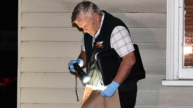 An officer during the raid. Picture: Ellen Smith