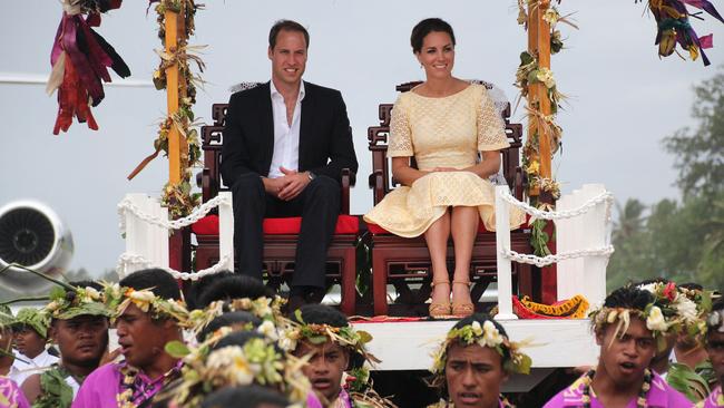 The royal couple are carried on thrones upon their arrival at Funafuti in Tuvalu.