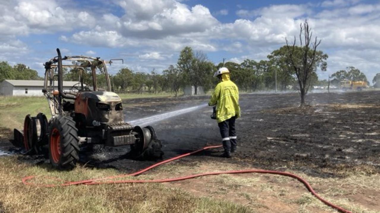 Emergency services were working to put out a grassfire and heavy machinery fire, which might have been started by it catching fire or exploding in a paddock next to several houses. Picture: Pamela McKay
