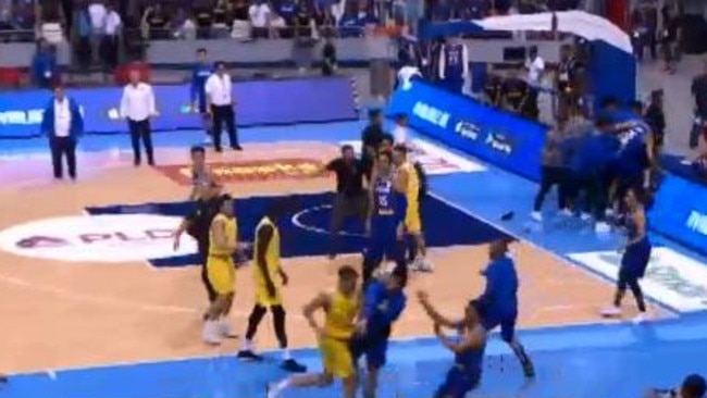 Kickert lands a left hook to a Philippines player following him as he makes his way down the court. The other players watch on.