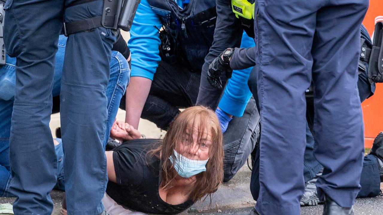 A woman appears to be arrested at the Shrine of Remembrance on Friday. Picture: Jake Nowakowski