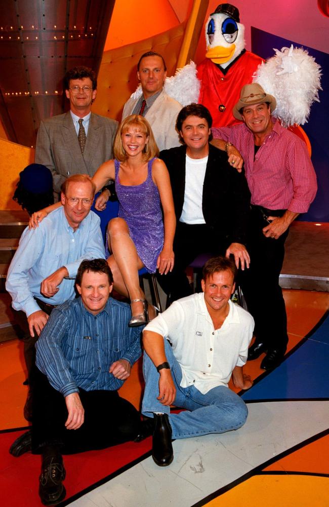 The Hey Hey cast, from the back: Red Symons, Wilbur Wilde and Plucka Duck. Middle row, John Blackman, Jo Beth Taylor, Daryl Somers and Ian 'Molly' Meldrum. Front row, Russell Gilbert and Cartoonist, Andrew Fyfe.