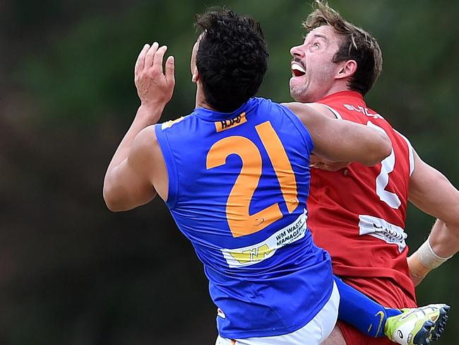 Eastern Football League Division 3: Warrandyte (red) versus Heathmont at Warrandyte Reserve.Warrandyte held a brief ceremony to mark its 1000th game and unfurl the three flags it won last year in 2015. Rucks Chris Nayna and Lee Evans at the centre bounce. Picture: Steve Tanner