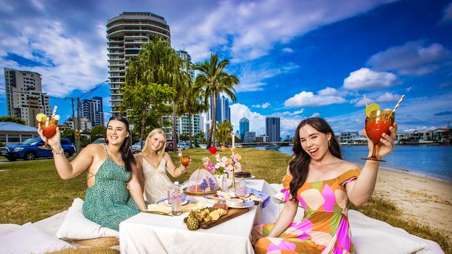 Pop Up Picnic. Jacklyn Nicholson (Green dress), Georgia Watt-Wright (white dress) and Helena Thomson (colourful dress) from the Lockyer Valley enjoy an Alfresco Pop Up Picnic at Budds Beach on the Gold Coast. Picture: NIGEL HALLETT