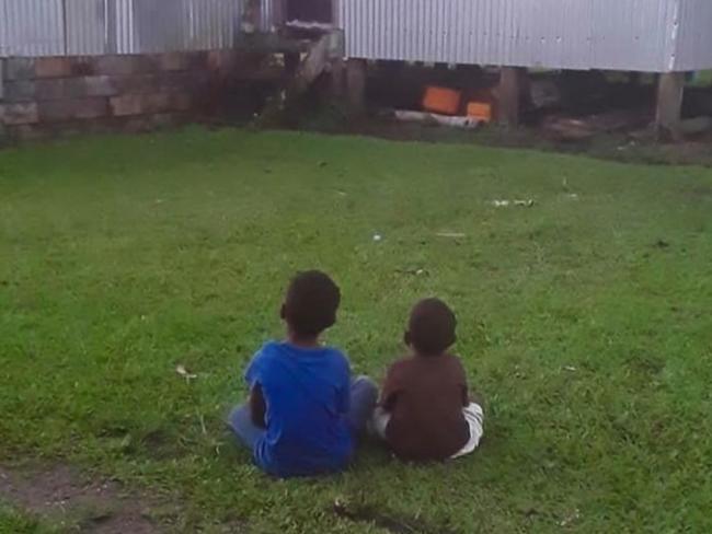 Two young boys watch the game. Picture: Teivovo Rugby