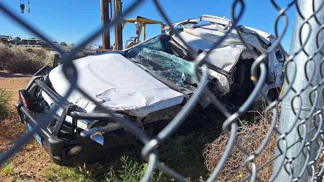 The totalled stolen car in a holding yard after being towed away from the crash scene.