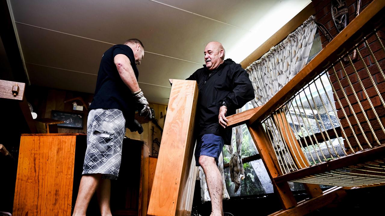 Homes in Bellevue Road Regentville NSW western Sydney affected by floods. Steven Wilson and Geoff Ryan removing damaged furniture. PictureÃ&#149;s Darren Leigh Roberts