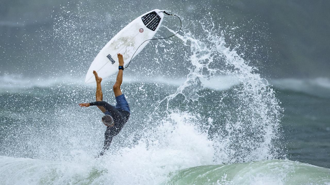 A surfer went airborne after taking to the swelling conditions at Mooloolaba as ex Tropical Cyclone Seth crosses the coast. Picture Lachie Millard