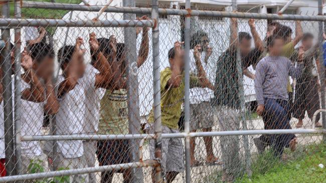 A March 21, 2014 file image of asylum seekers at the Oscar compound in the Manus Island detention centre, Papua New Guinea. The centre will be closed at the end of October. Picture: AAP